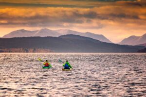 Kayaking and paddleboarding at sunset on Loch Rannoch
